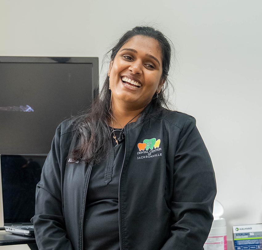 smiling female dental staff member of the Dental Center of Jacksonville, FL