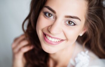Portrait of smiling woman with perfect smile and white teeth looking at camera.