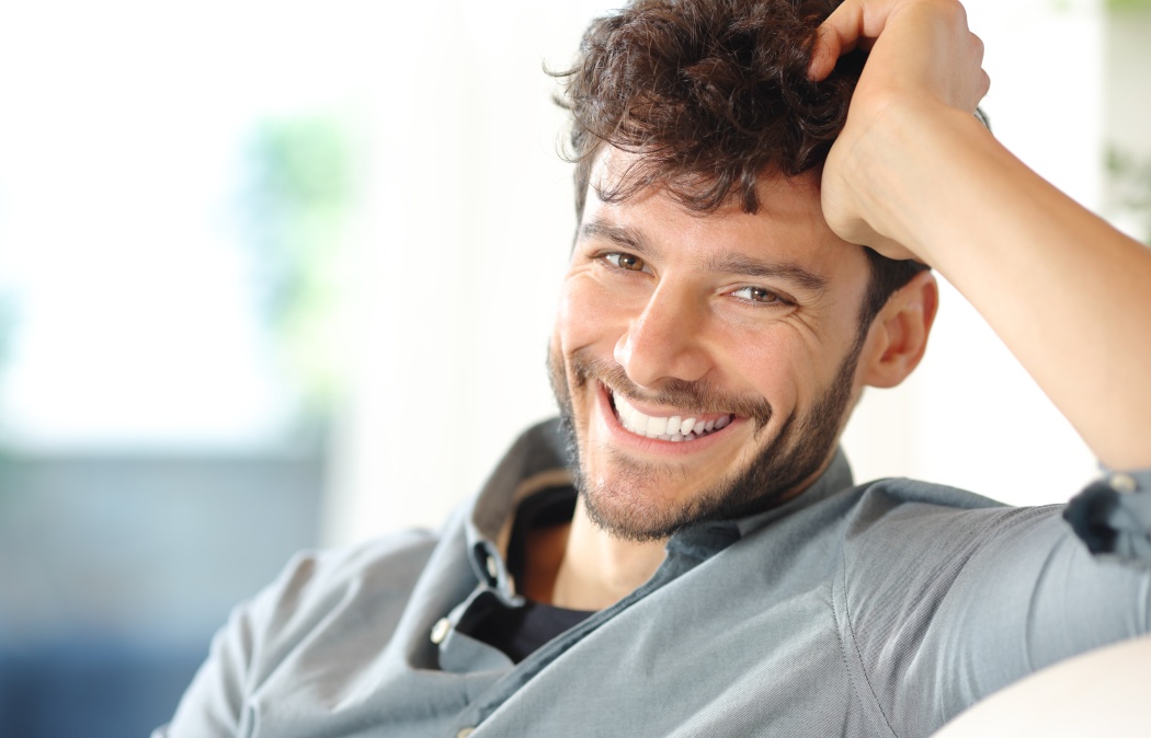 Portrait of a happy man with perfect smile looking at camera at home