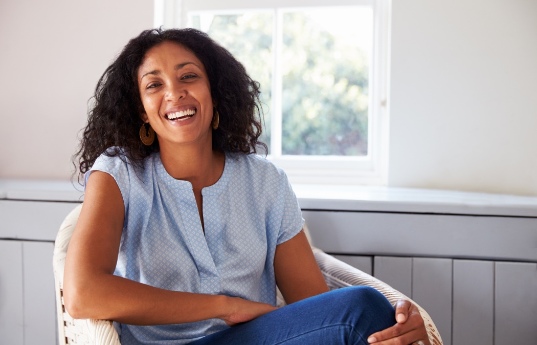 Portrait Of Woman Sitting In Chair At Home
