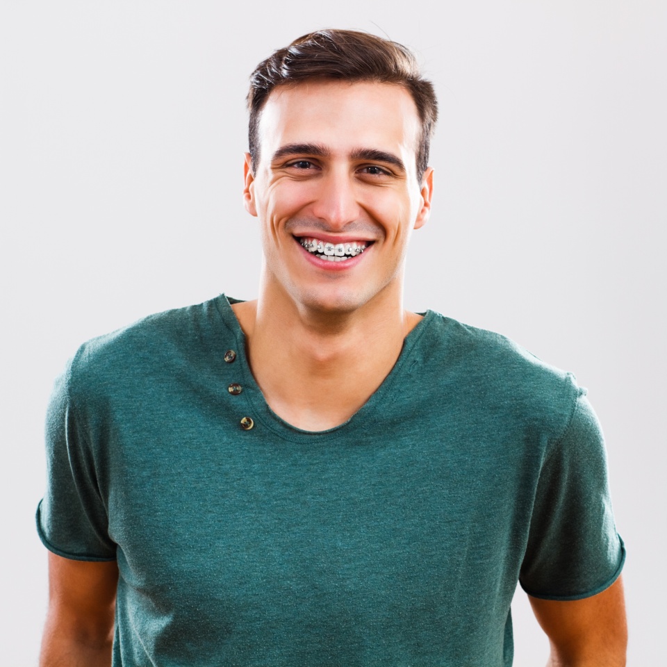 Portrait of content young man with braces.